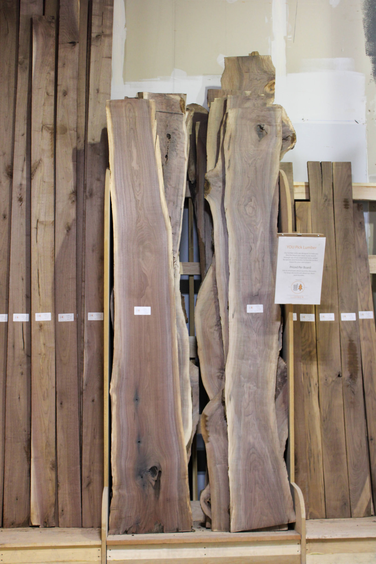 You-pick lumber rack of walnut boards priced per board