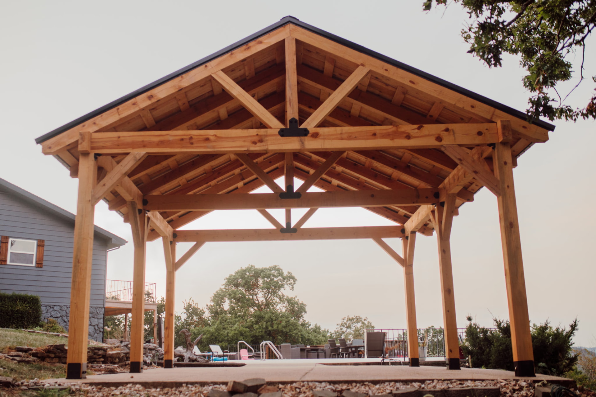 Premium timber pavilion kit installed by a pool