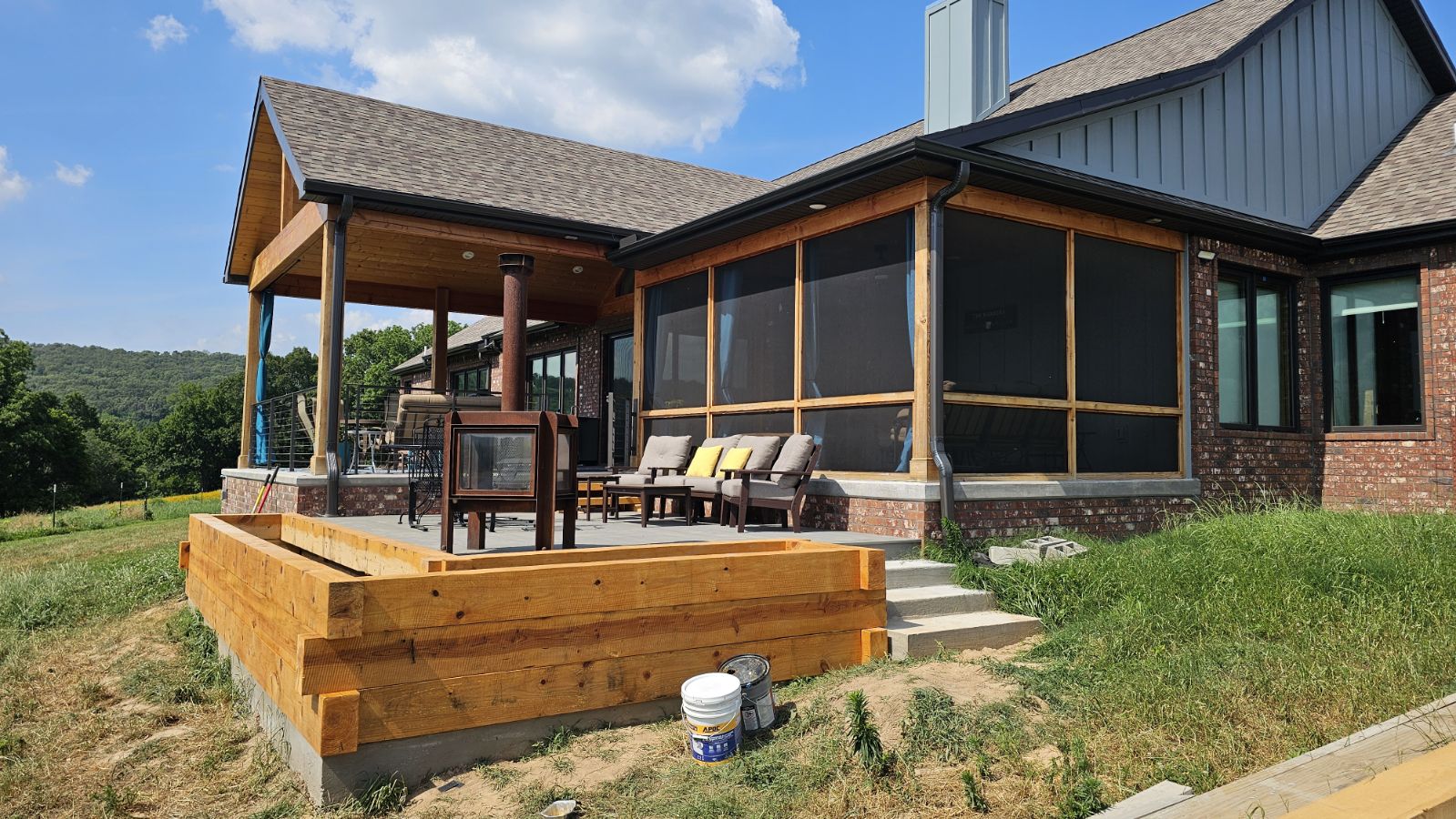 Timber deck and screened porch with beam retaining wall