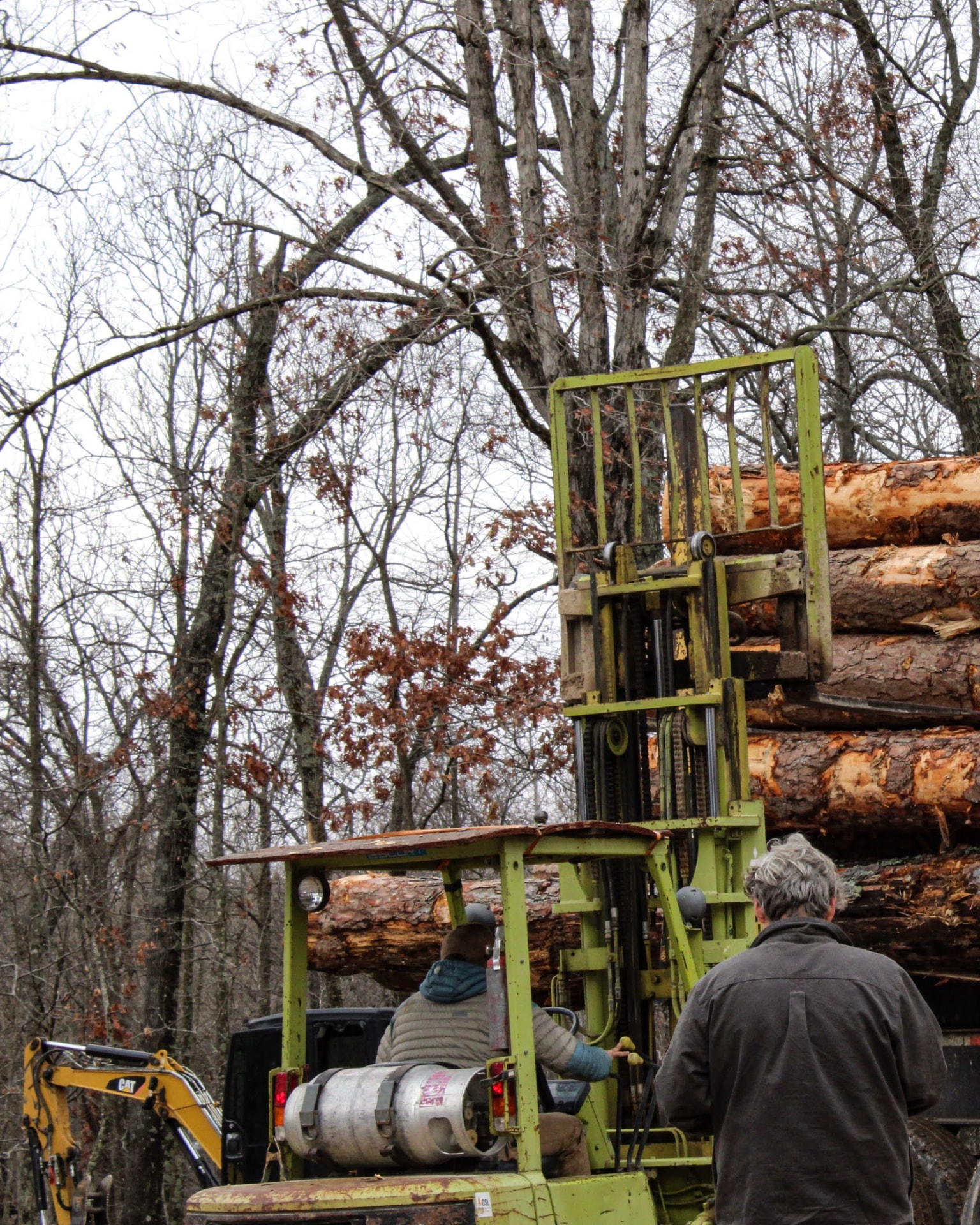 Levi & Grant unloading fresh logs at the sawmill