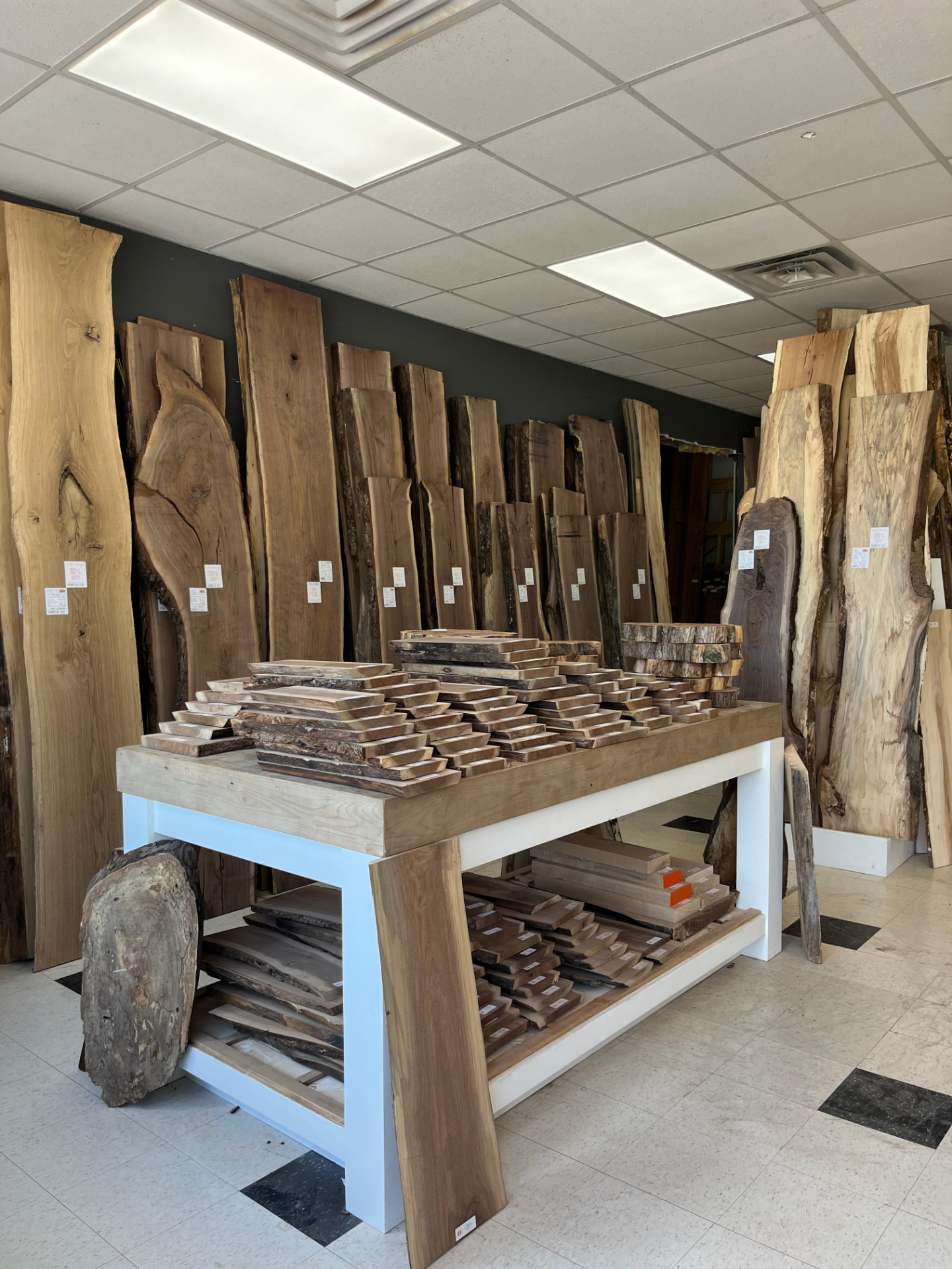 Showroom table with cutting boards and slab inventory