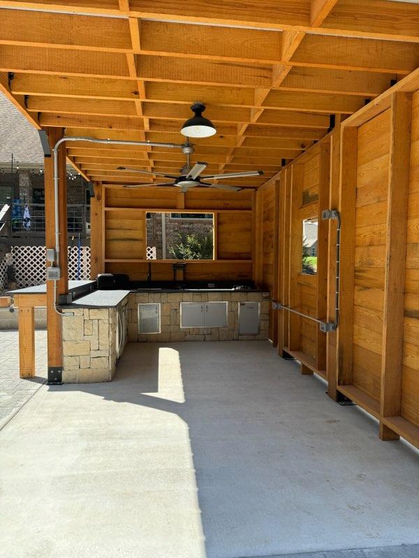 Covered outdoor kitchen with tongue and groove ceiling
